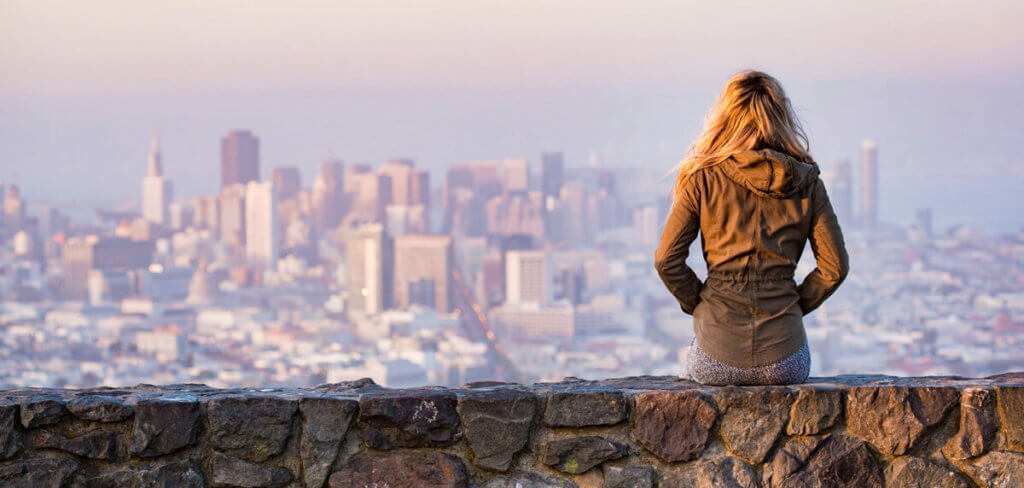 Woman looking out over a city