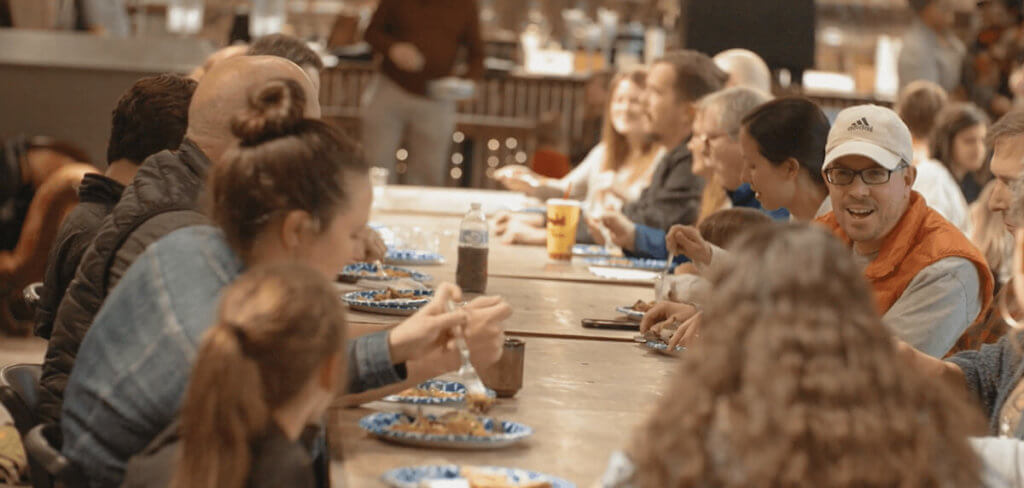 Group of people eating together at a large table