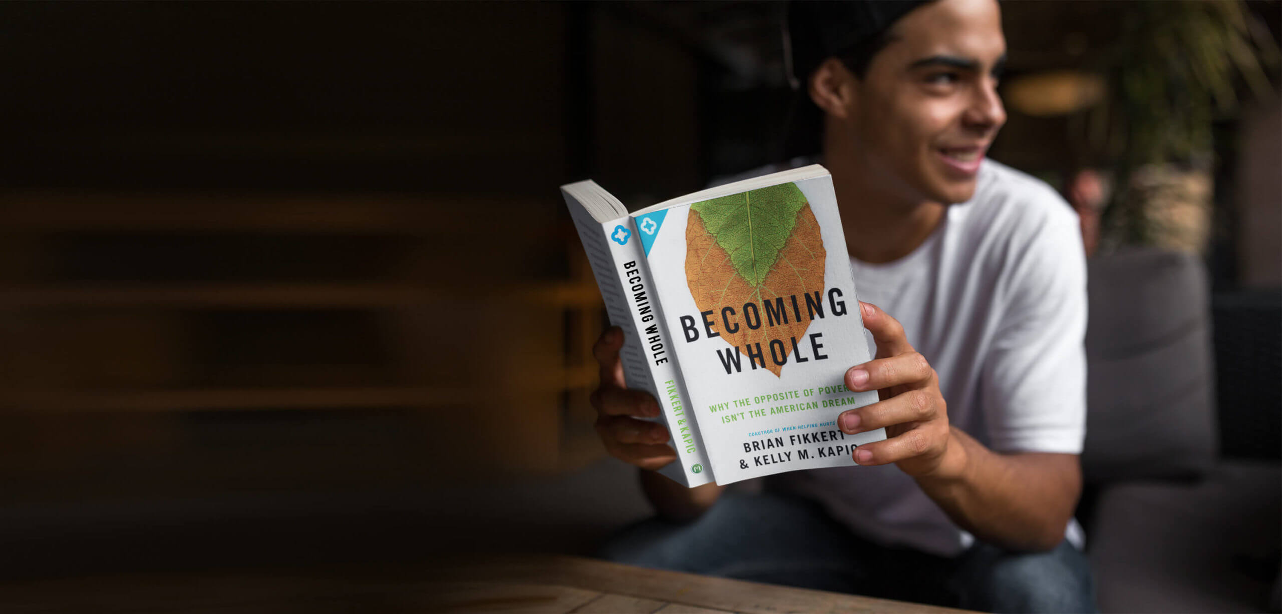 Man reading Becoming Whole book