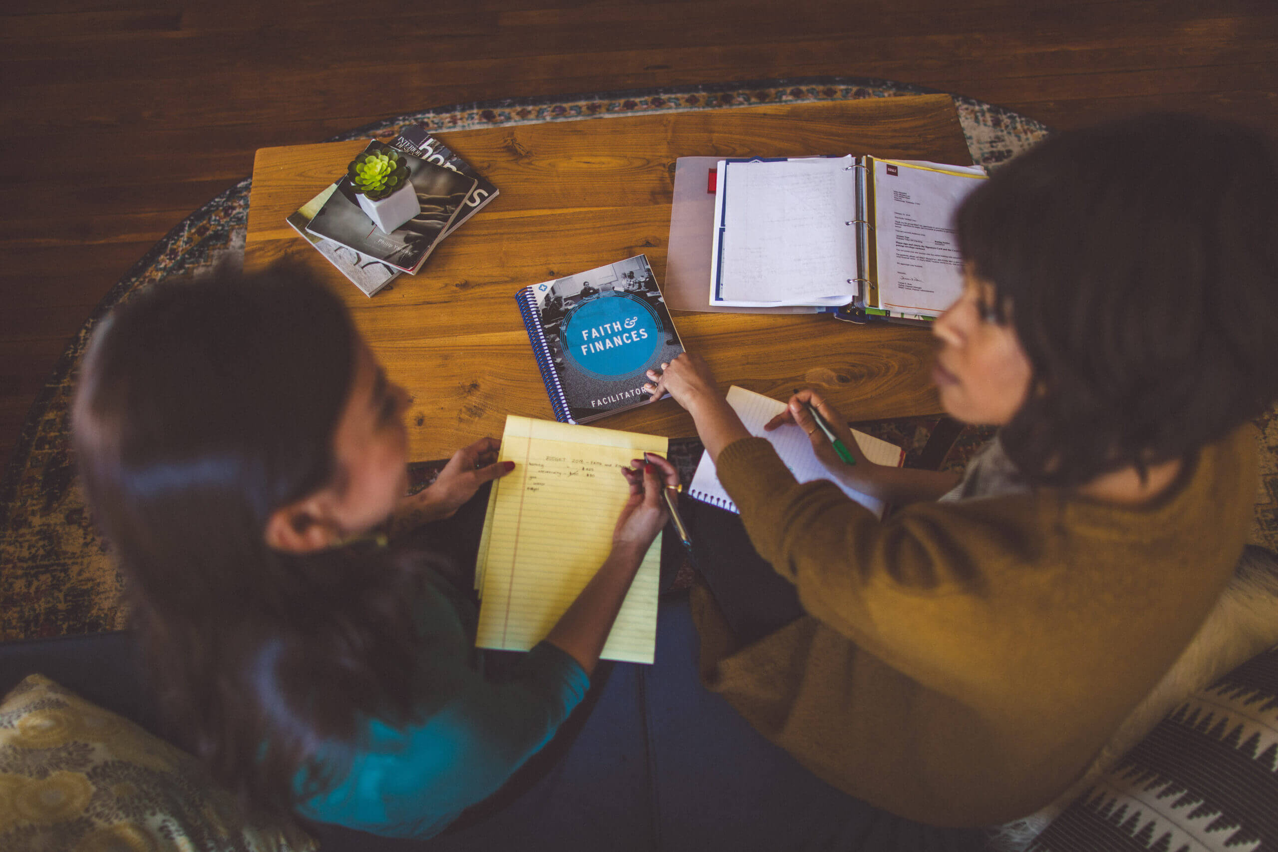 Two women looking at books together