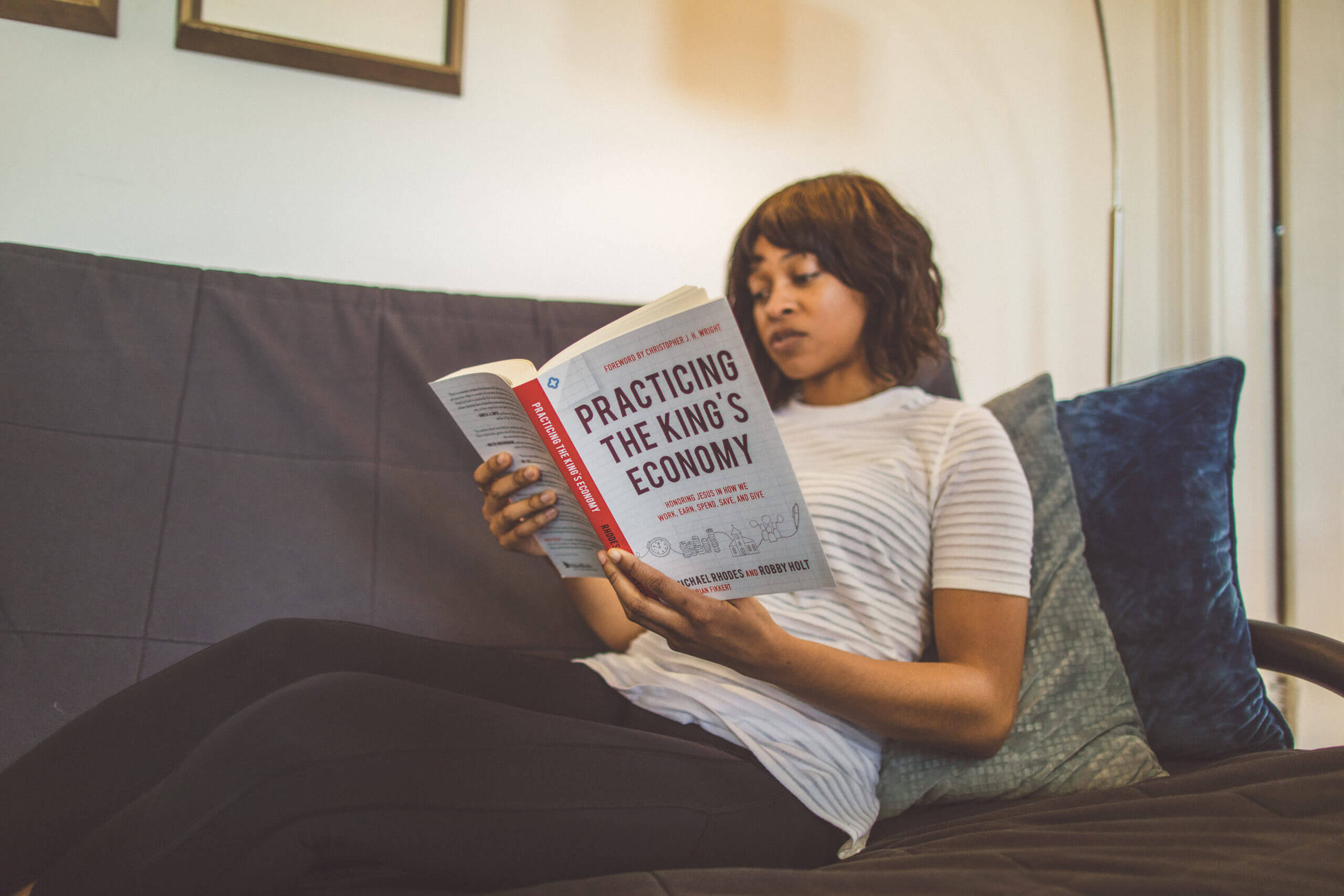 Woman reading a book on a couch
