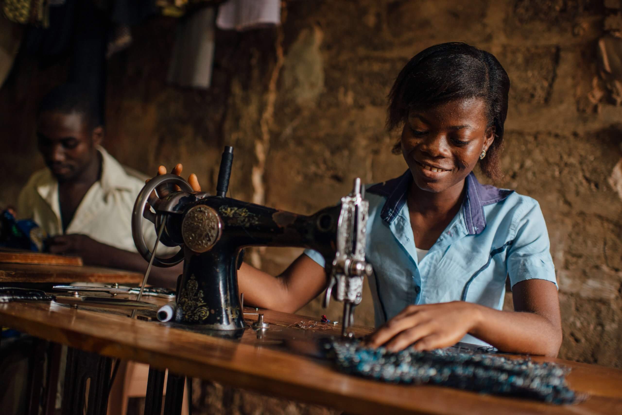 West African woman sewing